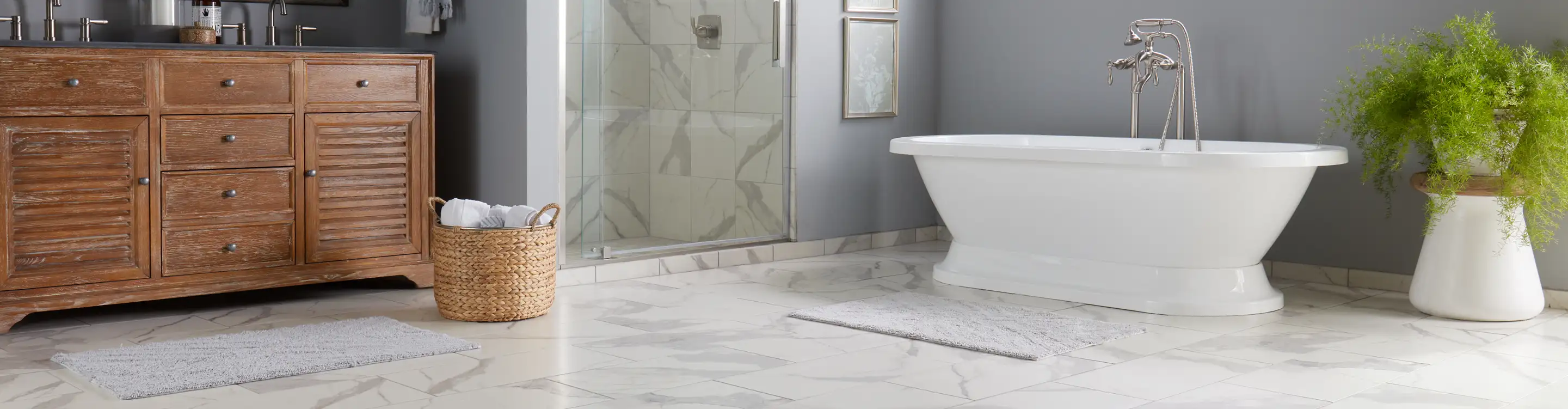 Marble tile floors and shower walls in a bathroom